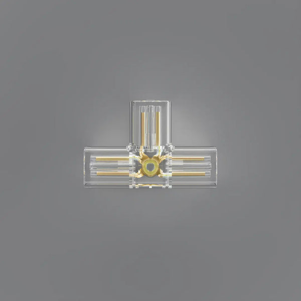A clear acrylic or glass wall sconce with gold-toned metal rods and a central circular gold accent, shown against a solid gray background.